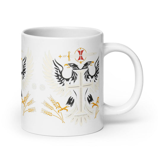 a white coffee mug with a cross and two birds on it