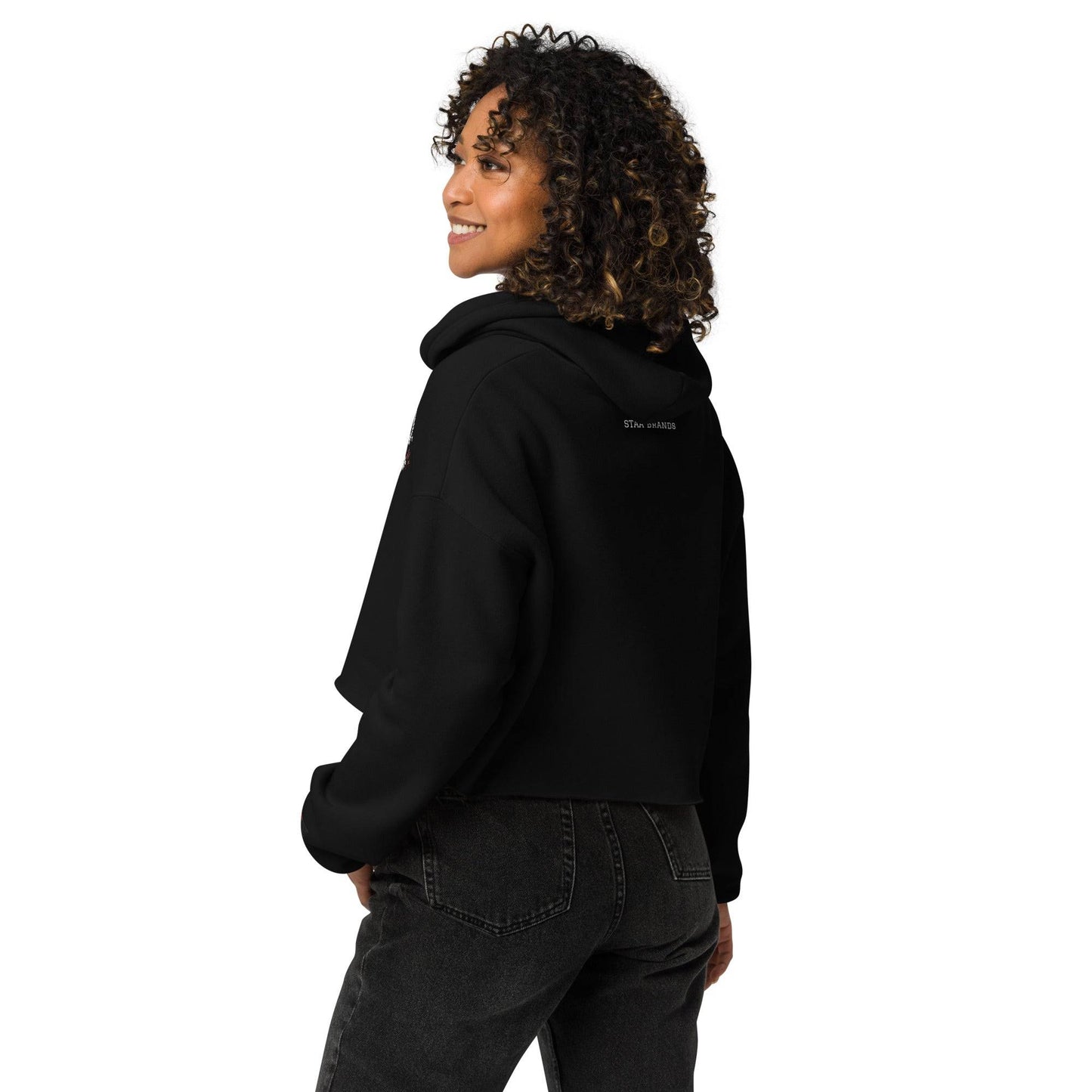 a woman wearing a black hoodie and jeans