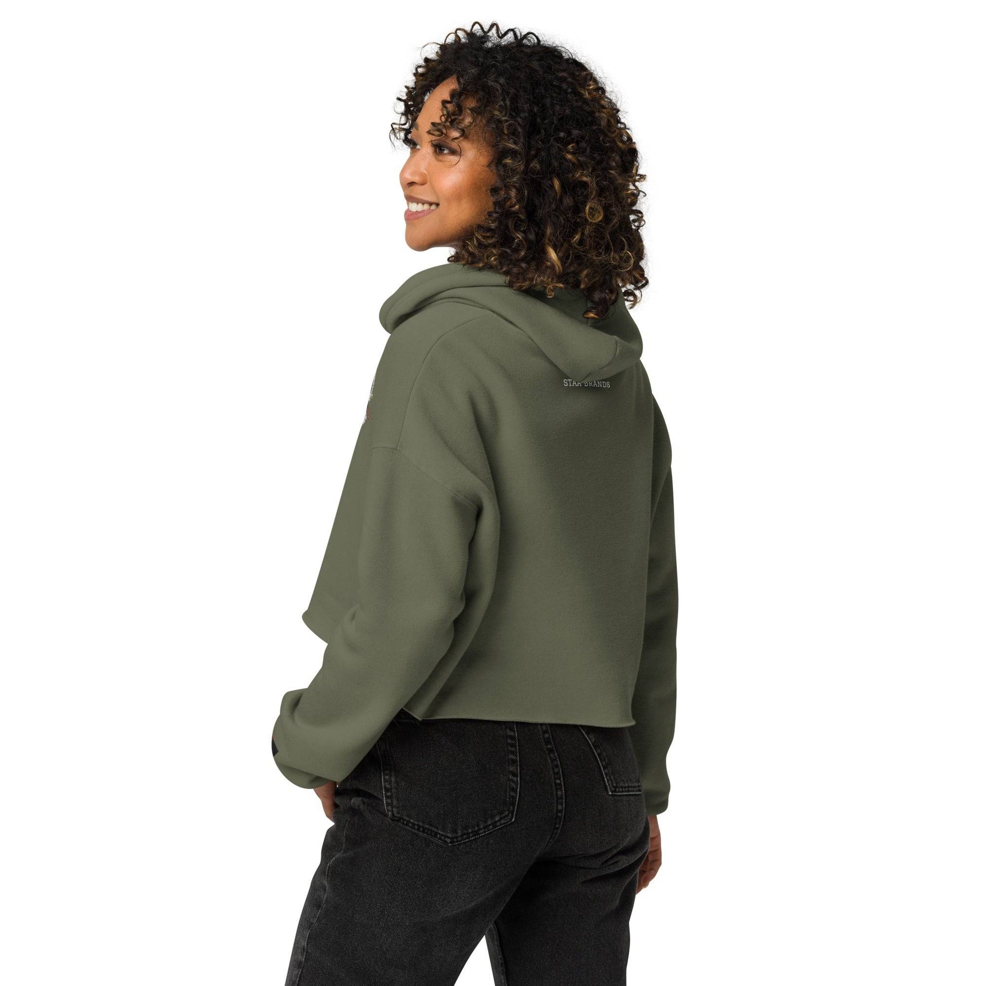 a woman wearing a green hoodie and black jeans