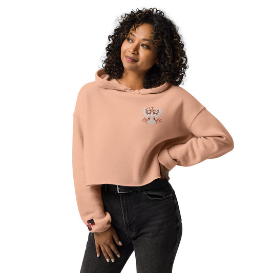a woman with curly hair wearing a pink sweatshirt
